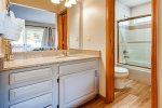 En-Suite guest bath with full tub and shower combination 